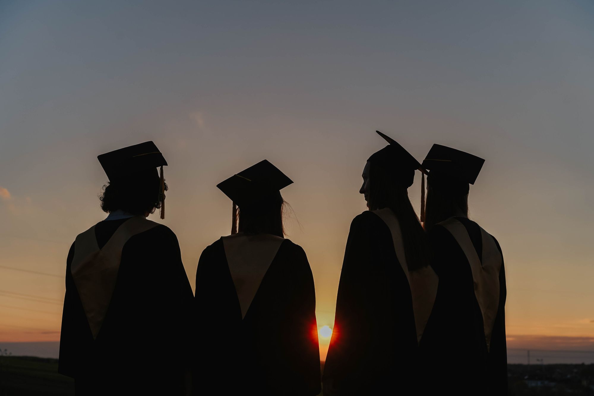 Graduates talking in the sunset