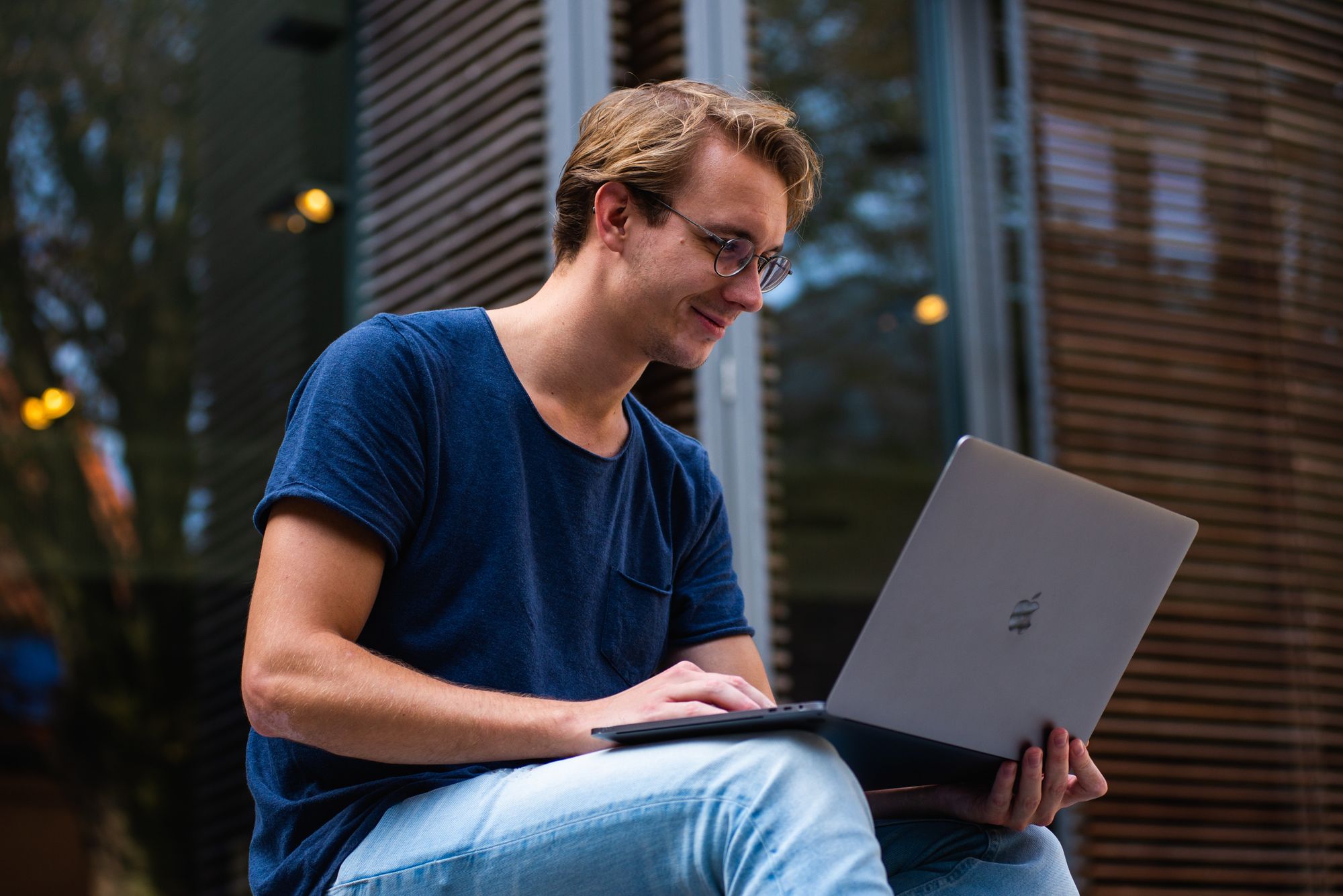 A man sitting down on his laptop
